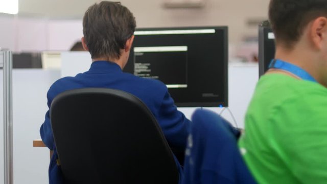 Professional IT programer working in data center - types the code
