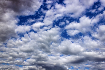 in the blue sky clouds and the sun.