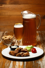 chicken wings in sweet sauce with beer and a pistachios