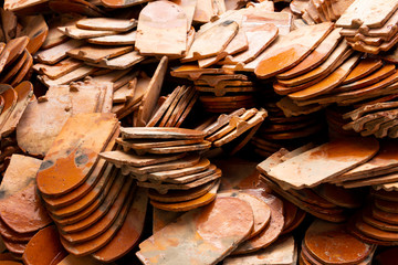 Stack of roof tiles traditional clay for temple construction process in vintage style which textured of surface natural color background.