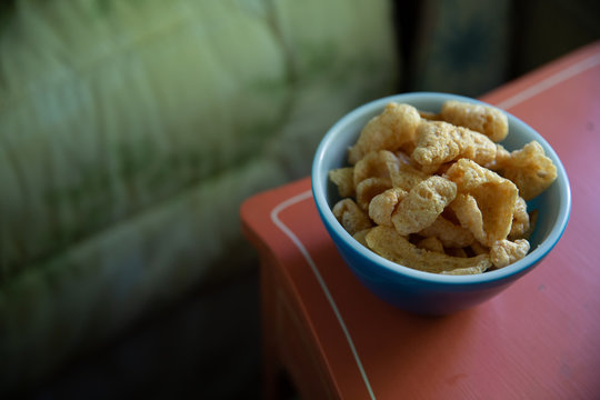 Pork skins in blue bowl