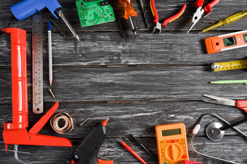 Top view of variety handy tools with different Jobs on black wooden background with copy space for your text for Worker's day, Labor's day, labour's day background.