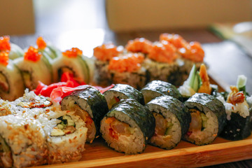 Philadelphia roll set on a wooden board in a restaurant