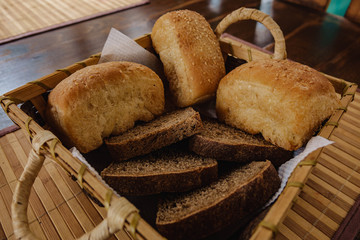 Composition with bread and rolls in wicker basket