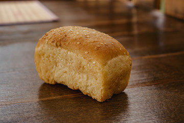 a loaf of white bread lying on a wooden table
