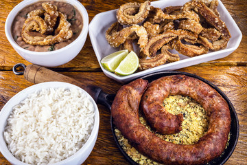 Typical food table in the interior of Brazil. Pork, beans, bean tutu, pork rinds, rice and farofa. Mining food, made at home. Flavors of Brazil.