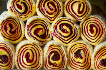 Oriental sweets on the counter of the store. Sweet rolls are folded with a pyramid. Organization of a presentation on a store shelf.