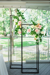 Beautiful composition with flowers on the tables and candles for guests at a wedding or a birthday party