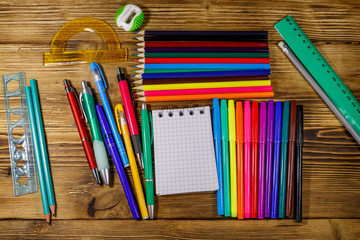Set of school stationery supplies on a wooden desk. Back to school concept