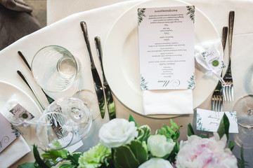 Beautiful composition with flowers on the tables and candles for guests at a wedding or a birthday party