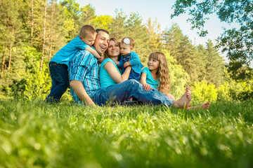 Naklejka na ściany i meble happy family outdoors in the park