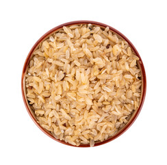 pounded unripe rice in bowl on white background