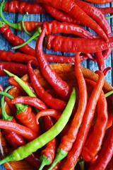Close-up of sliced chili peppers on an old wooden surface, selective focus.