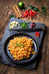 Korean style stir-fried instant noodle with a variety of Thai herbs, lime, red chilies, salt,...