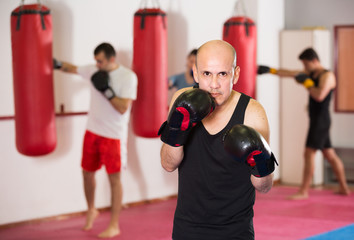 Portrait of boxer man which is practicing different kiks