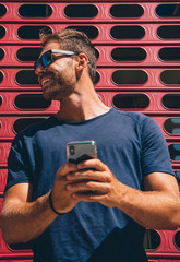handsome an using mobile phoneand wearnig sunglasses