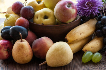 Naklejka na ściany i meble ripe fruits and flowers on the wooden table