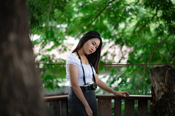 Naklejka premium Beautiful Asian woman with vintage film camera