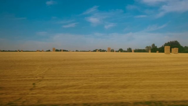 Passenger view of amazing croplands and rolling hills in the Cotswolds in England, UK, an Area of Outstanding Natural Beauty with 787 square miles, the second largest protected landscape in England