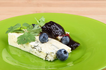 Blue cheese breakfast with blueberry jam and cilantro.