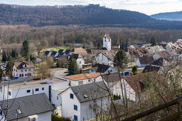 Fototapeta na wymiar Umiken near Brugg with church and view to the castle Habsburg. Aerial panoramic view.