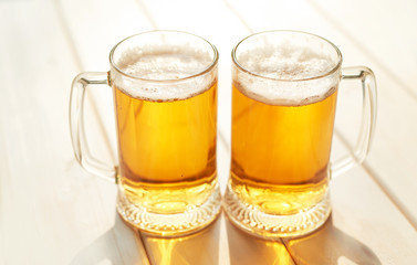 Oktoberfest beer. Glass beer mugs full of golden lager with thick frothy heads conceptual of  Oktoberfest. Beer mug. Big glass of lager beer from Bavaria and Munich Oktoberfest. Festival and Brewery
