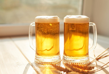 Oktoberfest beer. Glass beer mugs full of golden lager with thick frothy heads conceptual of  Oktoberfest. Beer mug. Big glass of lager beer from Bavaria and Munich Oktoberfest. Festival and Brewery