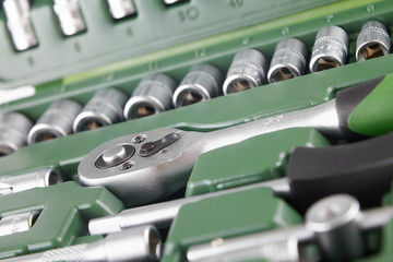 ratchet set with heads, different socket wrenches close-up in a green plastic case