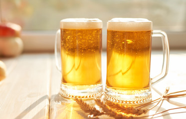 Oktoberfest beer. Glass beer mugs full of golden lager with thick frothy heads conceptual of  Oktoberfest. Beer mug. Big glass of lager beer from Bavaria and Munich Oktoberfest. Festival and Brewery