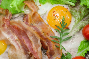 Sunny Side Up Eggs with crispy fried bacon, arugula and tomatoes