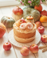 Naked Cake with Apples. Thanksgiving Day table. Happy Halloween Pumpkins, apples and flowers. Bright autumn background. Colorful autumn card. Autumn flower arrangement. Autumn bouquet