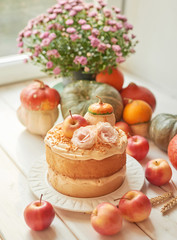 Naked Cake with Apples. Thanksgiving Day table. Happy Halloween Pumpkins, apples and flowers. Bright autumn background. Colorful autumn card. Autumn flower arrangement. Autumn bouquet