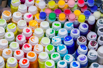 Acrylic, gouache paints, top view, paints in jars of all colors of the rainbow