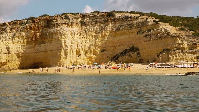 Wide tracking shot of a secluded beach along the coast of Carvoeiro, The Algarve, Portugal