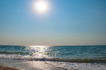 Bright sun over the sea. Sea waves.