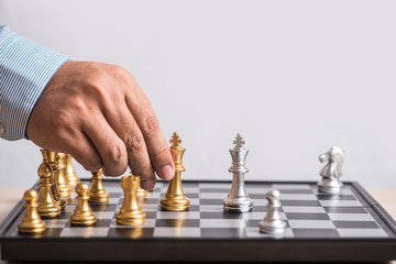 man hand handle gold king chess eliminate silver chess team