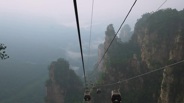 Famous touristic attraction. A cable car up to Huangshizhai crossing clouds. Scenic area Zhangjiajie National Forest Park in Wulingyuan, Hunan province,  China