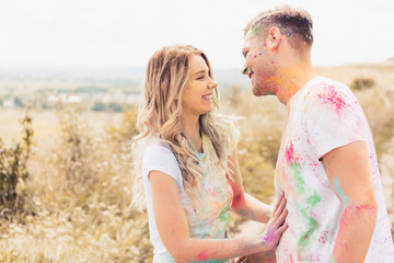 attractive woman and handsome man smiling and hugging outside