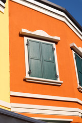 detail of the colorful orange house with window on clear sunny day in touristic place San Marino, Italy