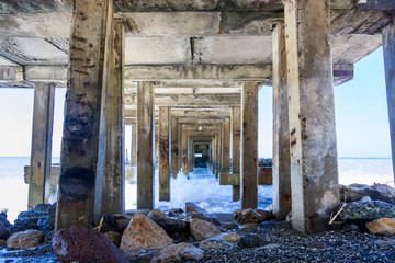 Fototapeta na wymiar old stone pilings of the abandoned pier
