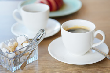 Hot coffee and croissant on background