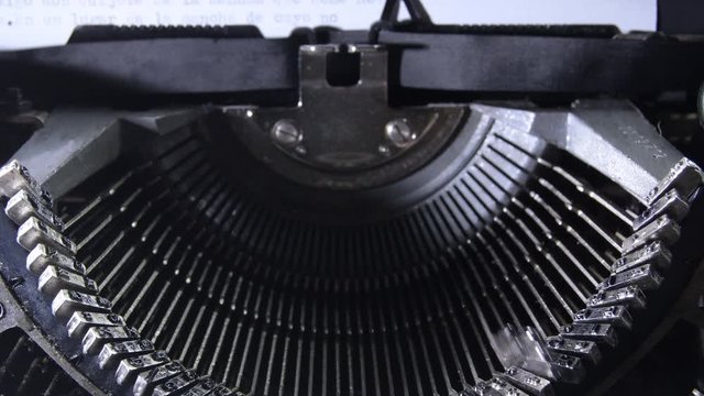 Letters hitting the paper while typing in an old qwerty typewriter with sound