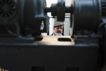 Man with beard working on printing press