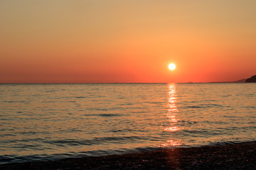 sunset on the ocean, mountains and nightfall