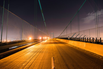 Night view of Vincent Thomas Bridge above the Port of Los Angeles, Terminal Island and San Pedro in...