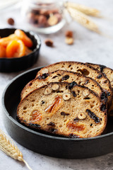 Slices of rye bread with hazelnuts and dried fruit like apricots, raisins and plums