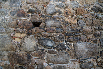 Granite stone wall with bricks