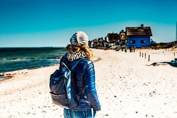 Woman baltic sea with houses on the beach
