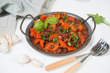 Healthy vegetarian meal of steamed vegetables. Red beans, paprika, tomatoes and greens stewed in tomato sauce. Traditional Caucasian dish - lobio.