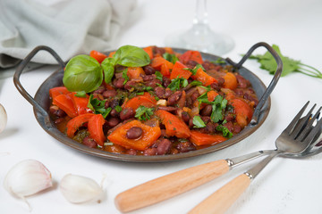 Healthy vegetarian meal of steamed vegetables. Red beans, paprika, tomatoes and greens stewed in tomato sauce. Traditional Caucasian dish - lobio.